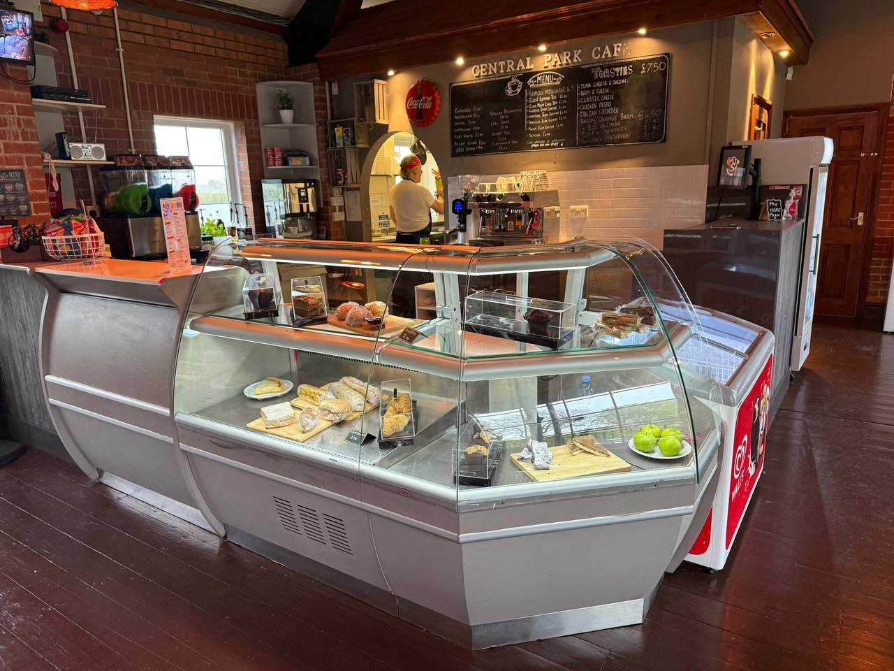 Inside Padel Park Eatery — the counter and cake cabinet